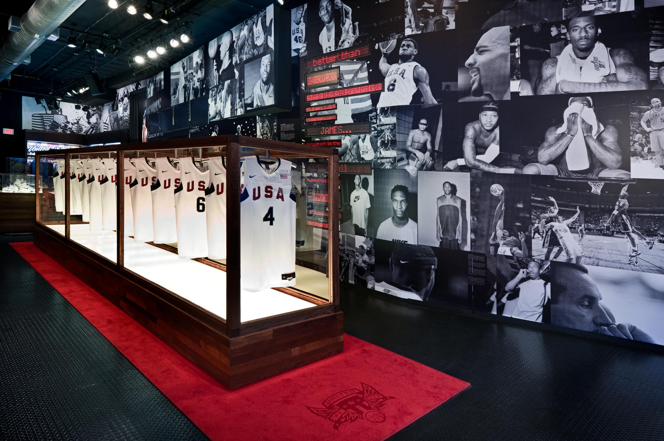 tops worn by numerous basketball stars in a glass display case at the NIKE gallery : NIKE : New York NY Architectural Photographer | Interior and Exterior