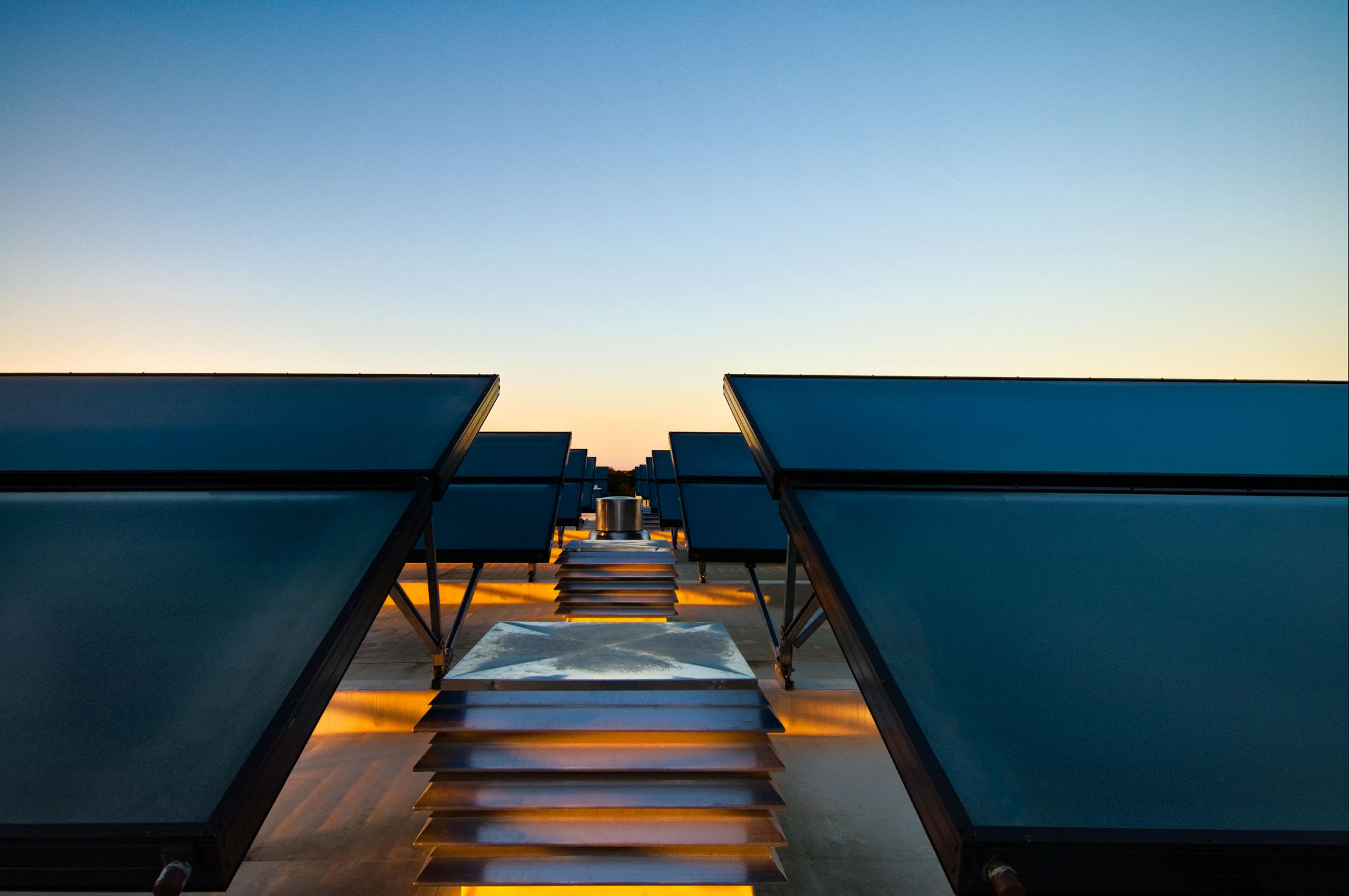 Sunset on the rooftop of the Proximity Hotel a LEED certified hotel utilizing solar panels to supply hot water to the rooms and restaurants. A Green hotel.   : Solar Powered Hotel  : New York NY Architectural Photographer | Interior and Exterior Photography