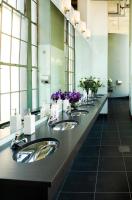 Whole Foods Market women washroom with with original fixtures from the 1930s. The flagship Whole Foods Market in London interior design was updated by Bottinogrund Architects in Austin, Texas - ©2025 Salem Krieger All Rights Reserved NYC Photographer